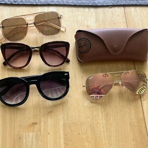 Four pairs of women sunglasses.  One pair is a high quality Ray-Ban.